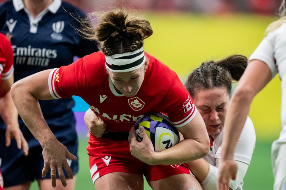 Canada's Laetitia Royer, left, is tackled by England's Amy Cokayne, right, during WXV 1 women's rugby union action, in Vancouver, on Saturday, Oct. 12, 2024. THE CANADIAN PRESS/Ethan Cairns