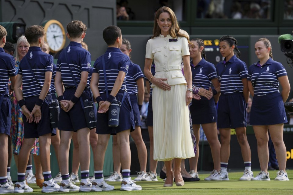 Kate, Princess of Wales speaks to ballboys and ballgirls as she participates in the presentation ceremony for the women's singles final at the Wimbledon Tennis Championships in London, Saturday, July 12, 2025. (AP Photo/Kin Cheung)