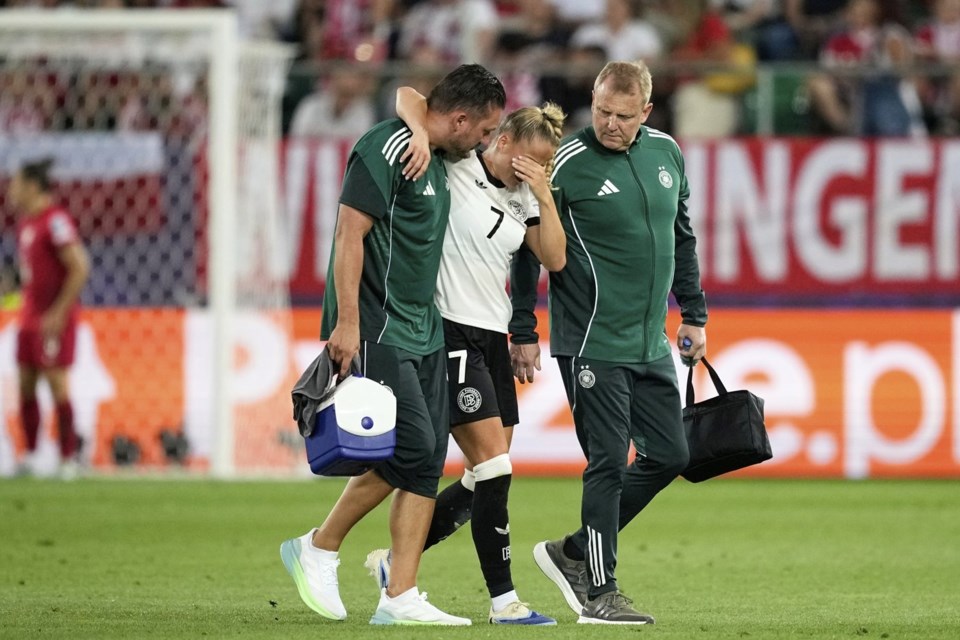 Germany's Giulia Gwinn leaves the pitch after getting injured during the Euro 2025, group C, soccer match between Germany and Poland at Arena St. Gallen in St. Gallen, Switzerland, Friday, July 4, 2025. (AP Photo/Martin Meissner)