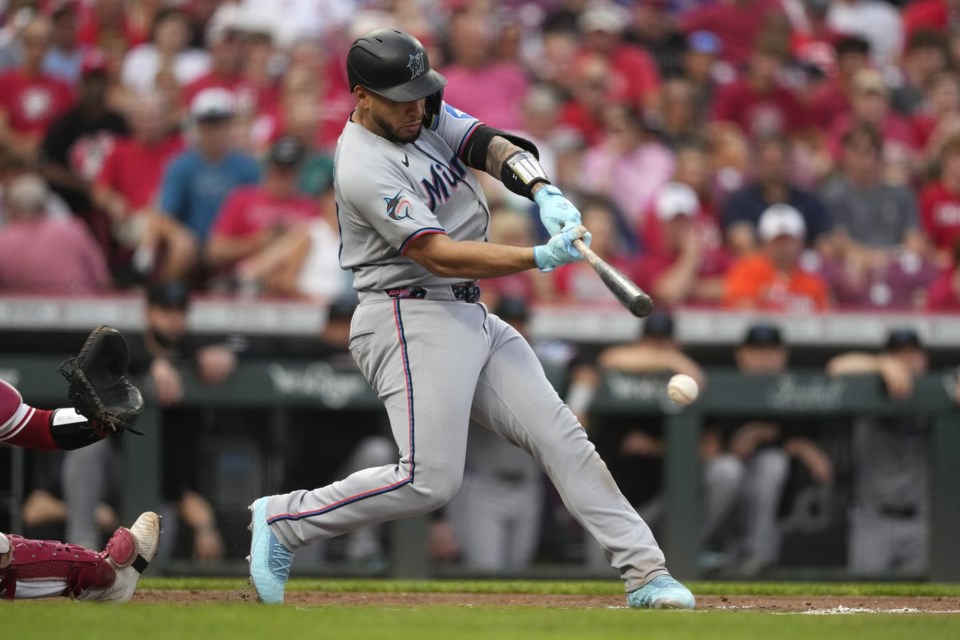 Miami Marlins' Agustín Ramírez doubles to score Jesús Sánchez during the third inning of a baseball game against the Cincinnati Reds in Cincinnati, Tuesday, July 8, 2025. (AP Photo/Carolyn Kaster)