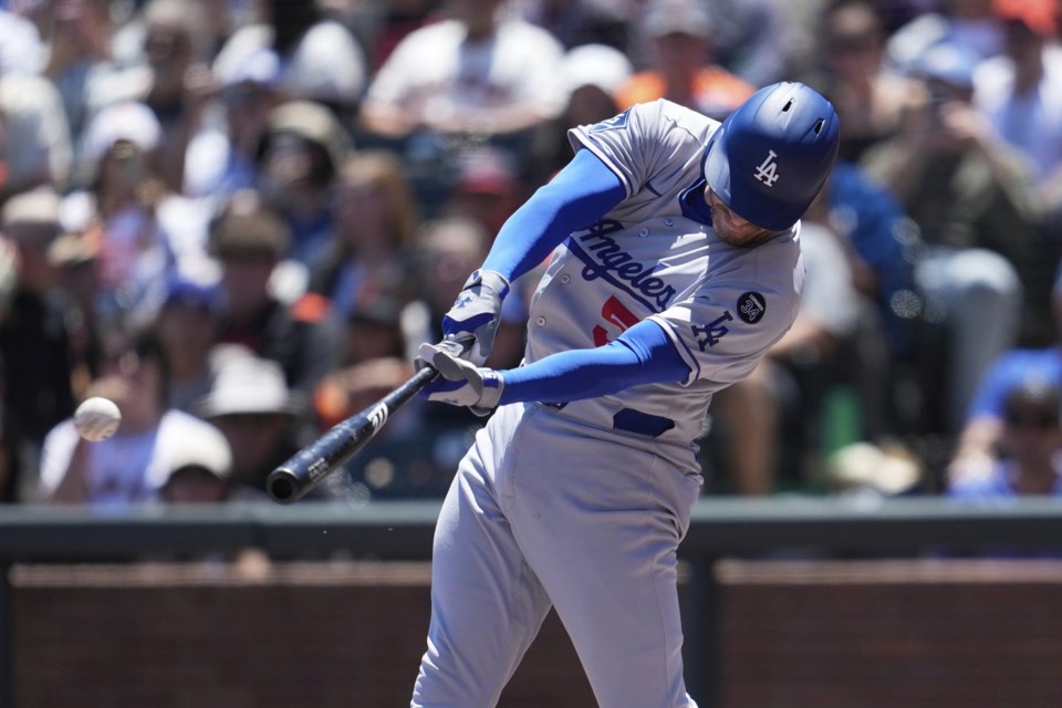 Los Angeles Dodgers' Freddie Freeman hits an RBI double against the San Francisco Giants during the fourth inning of a baseball game in San Francisco, Sunday, July 13, 2025. (AP Photo/Jeff Chiu)
