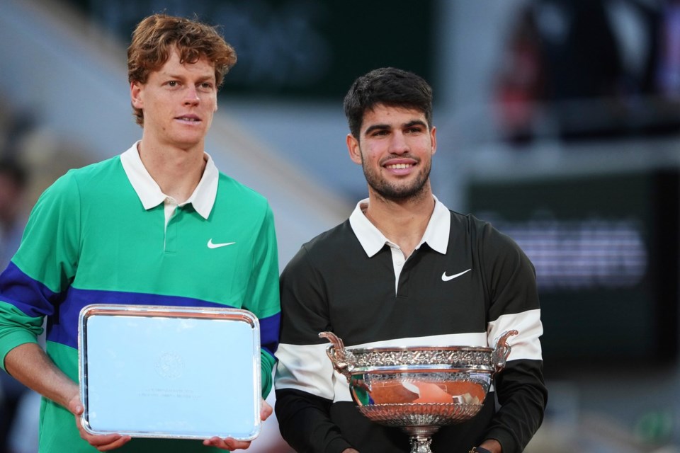 FILE - Winner Spain's Carlos Alcaraz, right, and second placed Italy's Jannik Sinner pose with trophies after the final match of the French Open tennis tournament at the Roland-Garros stadium in Paris, Sunday, June 8, 2025. (AP Photo/Lindsey Wasson, File)
