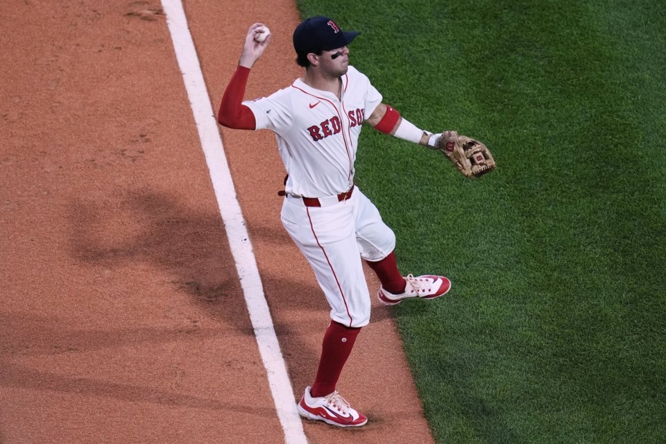 Boston Red Sox third baseman Marcelo Mayer fields a single by Cincinnati Reds' Christian Encarnacion-Strand during the third inning of a baseball game at Fenway Park, Tuesday, July 1, 2025, in Boston. (AP Photo/Charles Krupa)