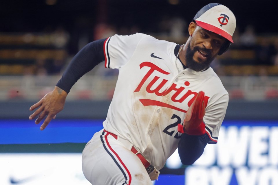 Minnesota Twins' Byron Buxton rounds third base en route to scoring on a single by Willi Castro against the Seattle Mariners in the sixth inning of a baseball game Wednesday, June 25, 2025, in Minneapolis. (AP Photo/Bruce Kluckhohn)