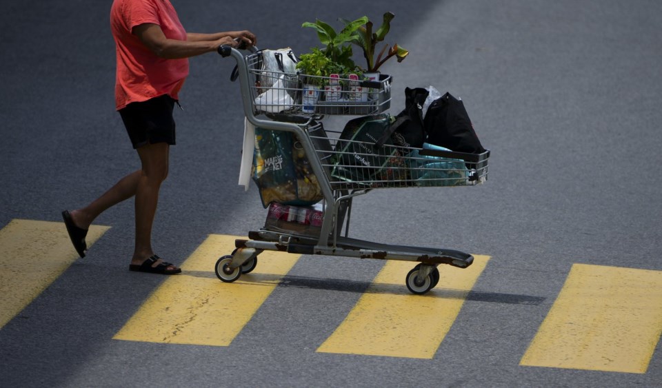 Statistics Canada is set to release June inflation figures on Tuesday. A shopper pushes a shopping carts as they leave a Real Canadian Superstore in Ottawa on Tuesday, June 25, 2024. THE CANADIAN PRESS/Sean Kilpatrick