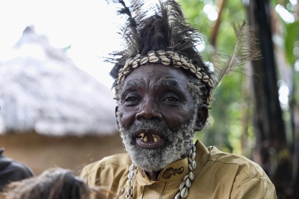 Seer Atukung Tafala speaks during an interview with The Associated Press outside his igloo-like shrine in Kampala, Uganda, on Saturday, June 21, 2025. (AP Photo/Hajarah Nalwadda)