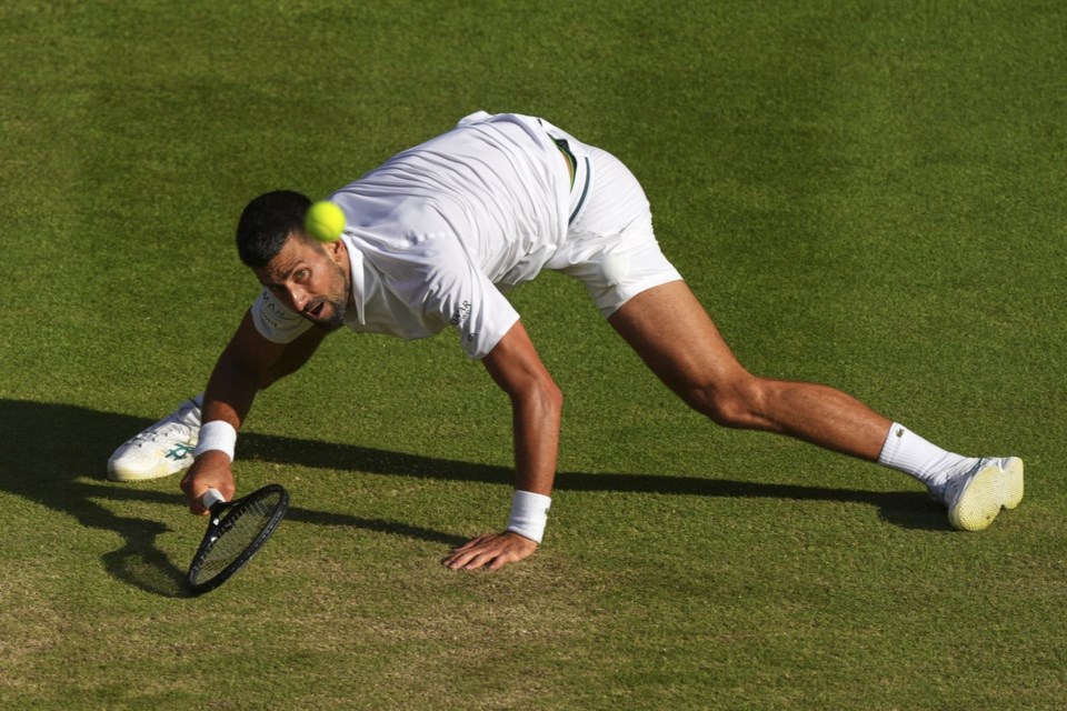 Serbia's Novak Djokovic returns to Italy's Flavio Cobolli during a quarterfinal men's singles match at the Wimbledon Tennis Championships in London, Wednesday, July 9, 2025. (AP Photo/Joanna Chan)