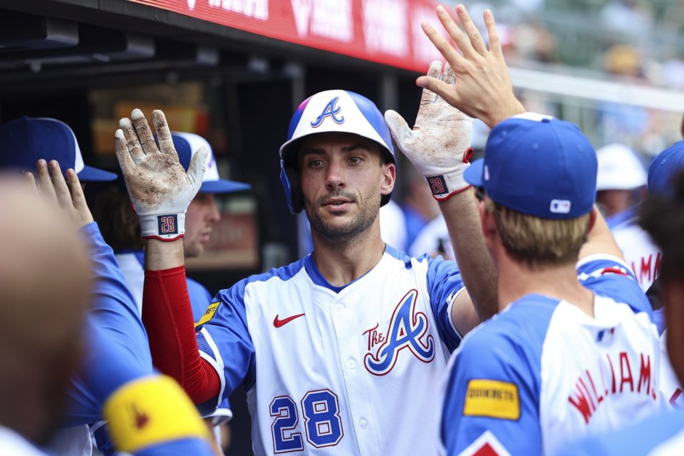 Atlanta Braves' Matt Olson (28) high-fives teammates in the dugout after hitting a solo home run in the third inning of a baseball game against the Baltimore Orioles, Saturday, July 5, 2025, in Atlanta. (AP Photo/Colin Hubbard)