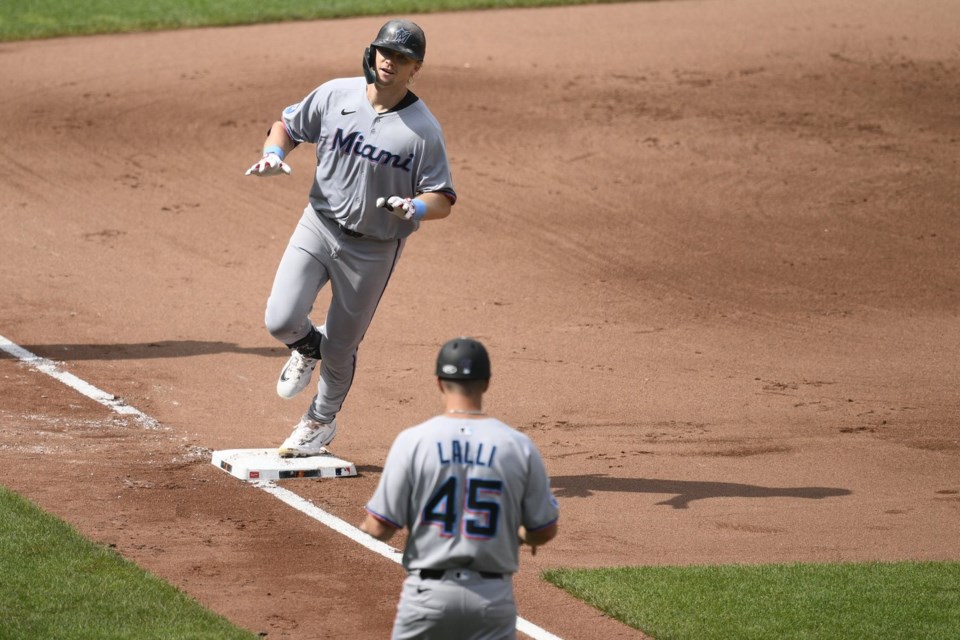 Miami Marlins' Kyle Stowers, top, celebrates after his two-run home run next to third base coach Blake Lalli (45) as he rounds the bases during the fifth inning of a baseball game against the Baltimore Orioles, Sunday, July 13, 2025, in Baltimore. (AP Photo/Nick Wass)