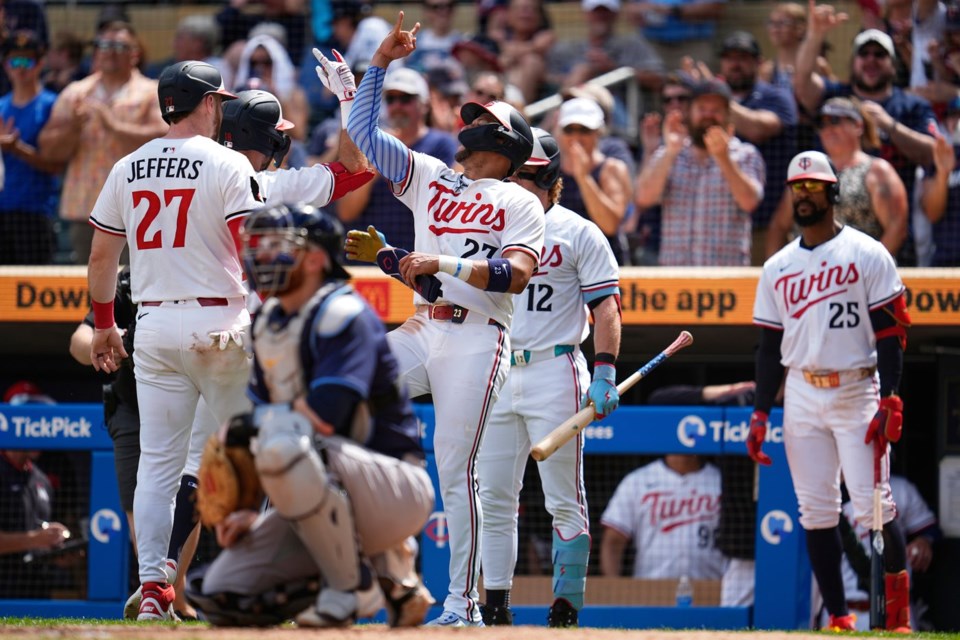 Minnesota Twins' Kody Clemens (18), back, left, celebrates with teammates after hitting a 3-run home run during the sixth inning of a baseball game against the Tampa Bay Rays Saturday, July 5, 2025, in Minneapolis. (AP Photo/Abbie Parr)