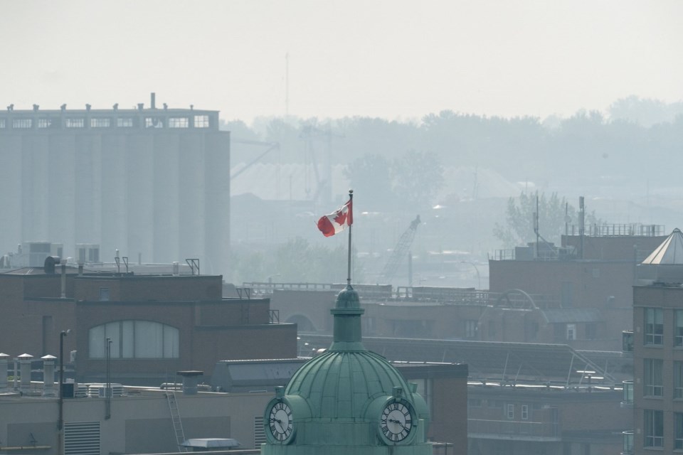 A Canadian flag flies on a flagpole amid a hazy sky, caused by smoke from wildfires burning in Canada's prairie provinces, in Toronto, Friday, June 6, 2025. THE CANADIAN PRESS/Giordano Ciampini
