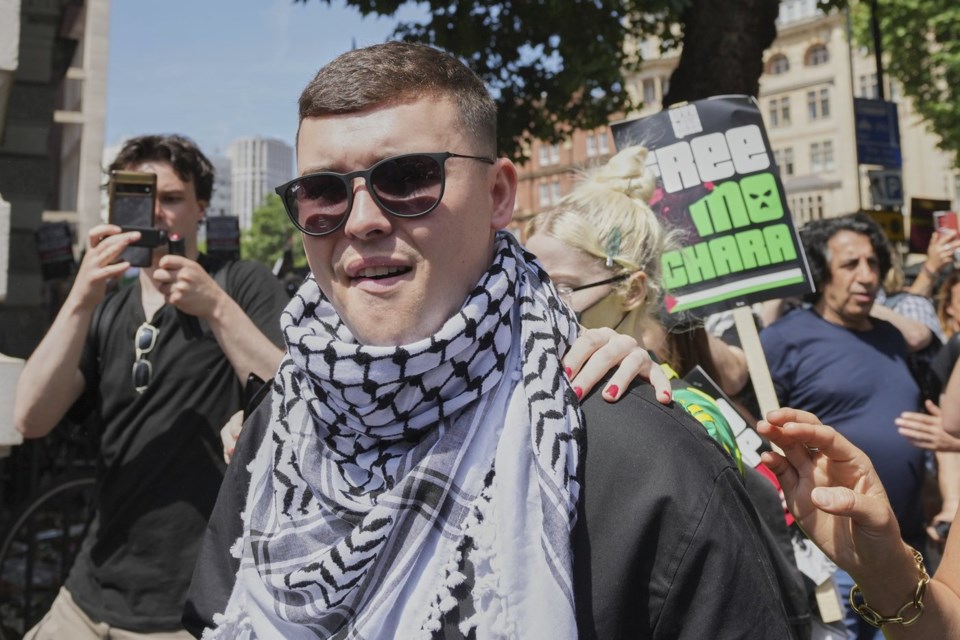 Liam Óg Ó hAnnaidh, aka Mo Chara, a member of the Irish language band Kneecap, leaves Westminster Magistrates Court London, Wednesday, June 18, 2025, where he is charged with a terrorism offence relating to displaying a flag in support of Hezbollah during a performance with the band in November 2024. (AP Photo/Kin Cheung)