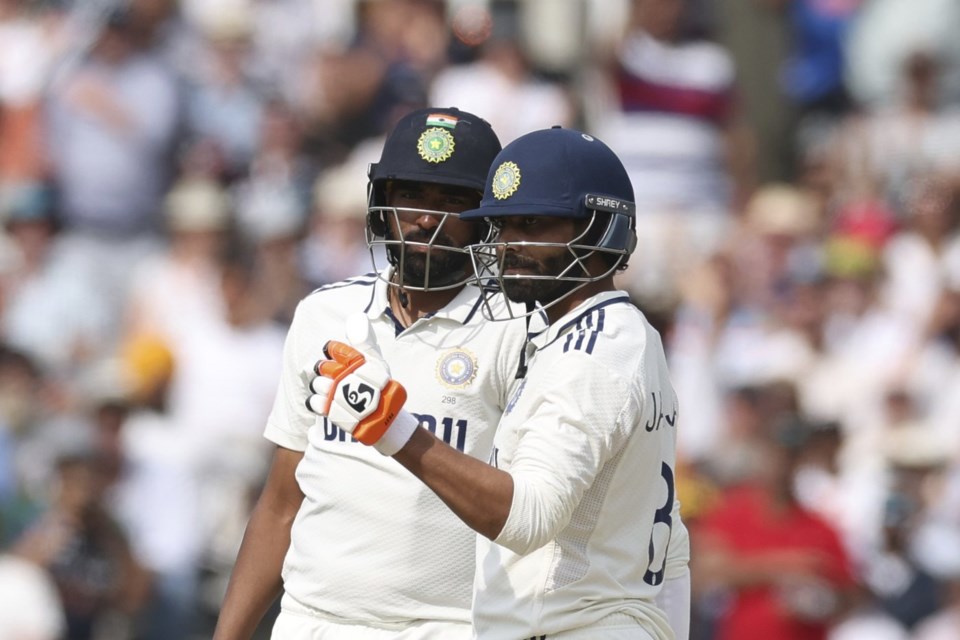 India's Ravindra Jadeja, right, celebrates after scoring fifty runs during the fifth day of the third cricket test match between England and India at Lord's cricket ground in London, Monday, July 14, 2025. (AP Photo/Richard Pelham)