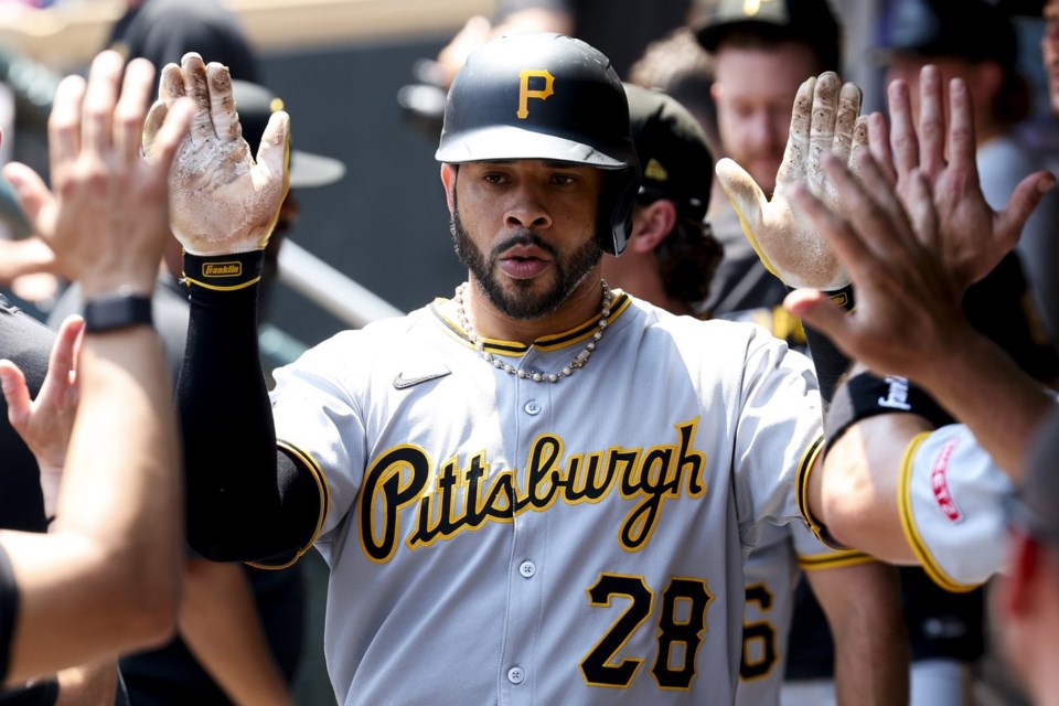 Pittsburgh Pirates' Tommy Pham celebrates in the dugout after hitting a single home run during the second inning of a baseball game against the Minnesota Twins Sunday, July 13, 2025, in Minneapolis. (AP Photo/Ellen Schmidt)