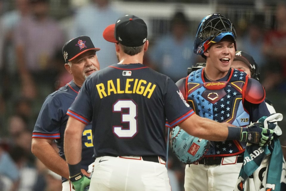 Seattle Mariners' Cal Raleigh, watches with his dad Todd who pitched and brother Todd Jr. catcher during the MLB baseball All-Star Home Run Derby, Monday, July 14, 2025, in Atlanta. (AP Photo/Brynn Anderson)