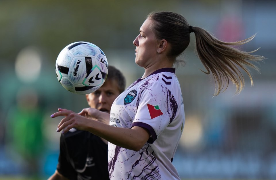 Halifax Tides' Saorla Miller, front left, controls the ball while being watched by Vancouver Rise's Quinn during the first half of an NSL soccer match, in Burnaby, B.C., on Monday, May 5, 2025. THE CANADIAN PRESS/Darryl Dyck