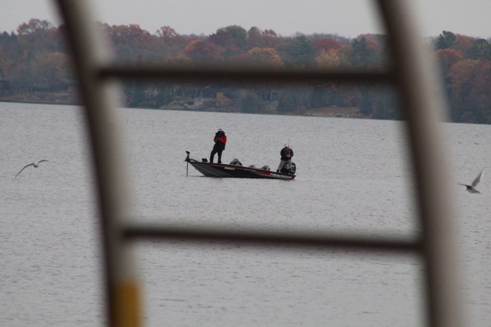 A pair of anglers try their luck along the shores of Kempenfelt Bay in Barrie in this file photo. Raymond Bowe/BarrieToday
