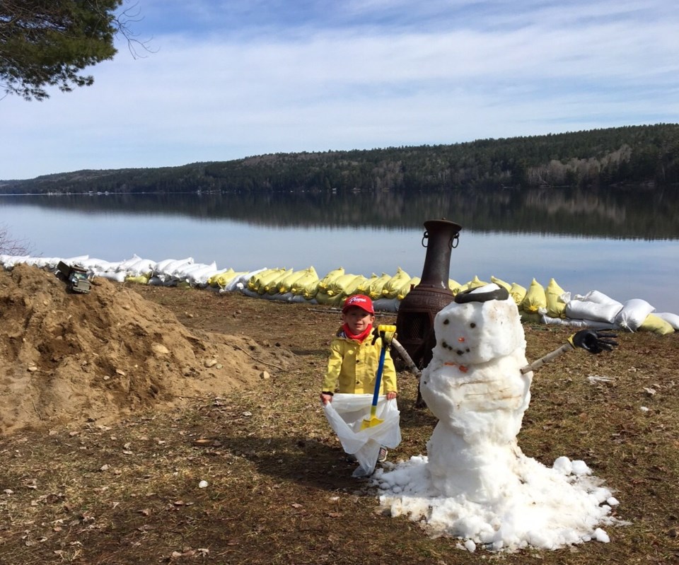 USED 2019-05-16goodmorning  2 Remorseful snowman fills sandbags. Photo courtesy of Bert Langlois, Temiscaming.