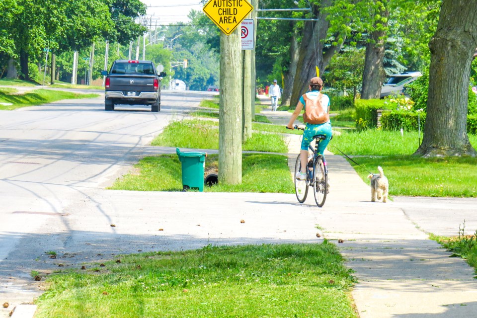 USED 07-july-4-2023-woman-bike-dog