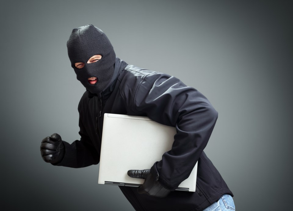 laptop theft thief mask stock