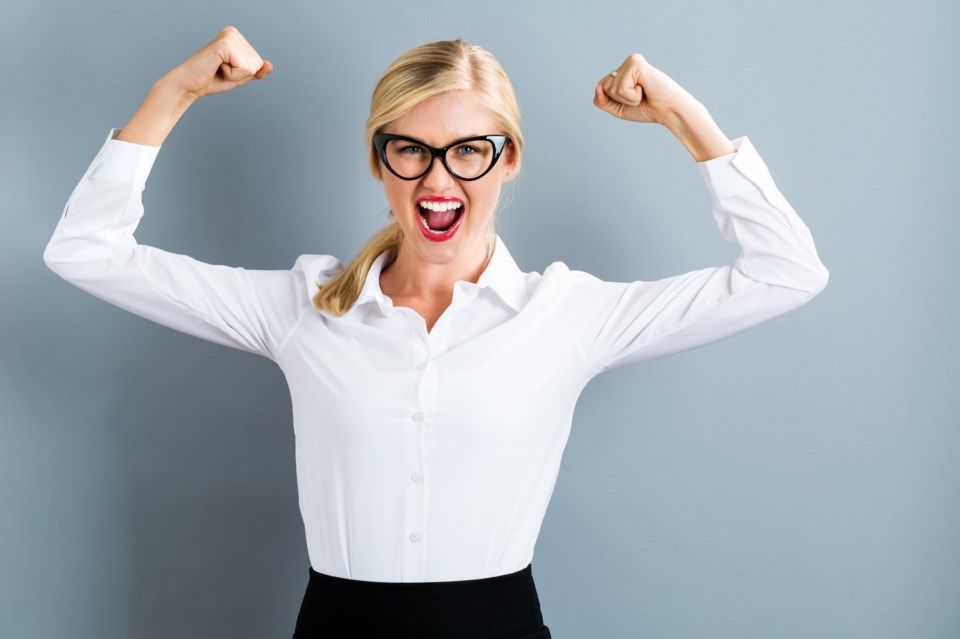 powerful woman flexing muscles stock