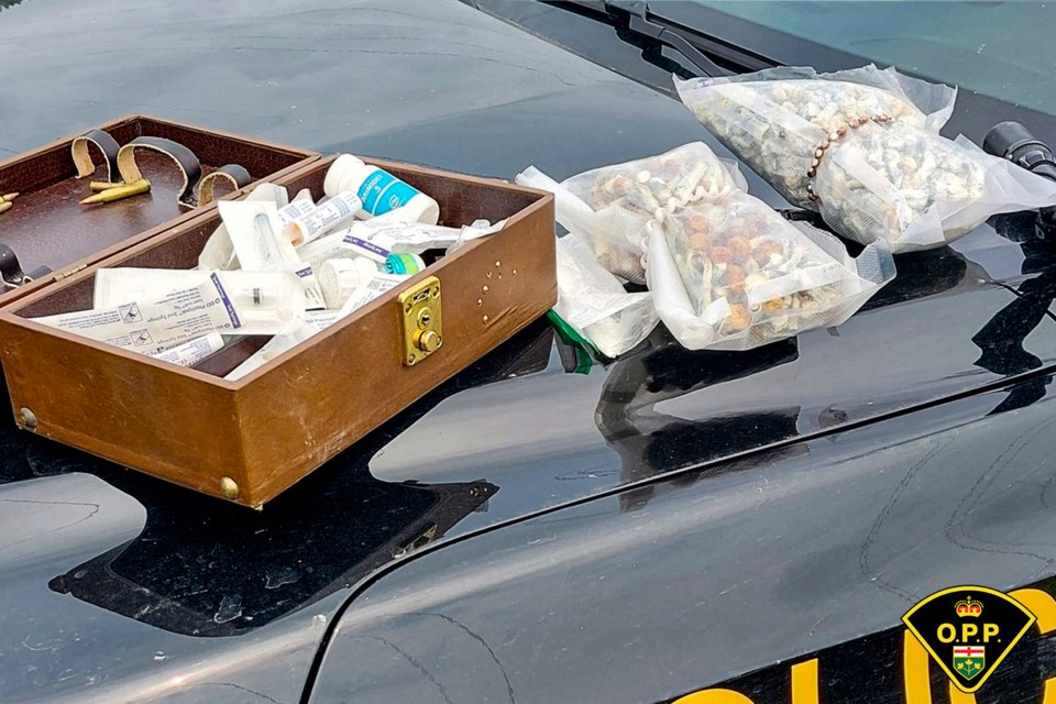 OPP search the belongings of a 40-year-old from Carievale, Sask. on Monday, Aug. 4, 2025 near Three Finger Lake. (OPP handout)