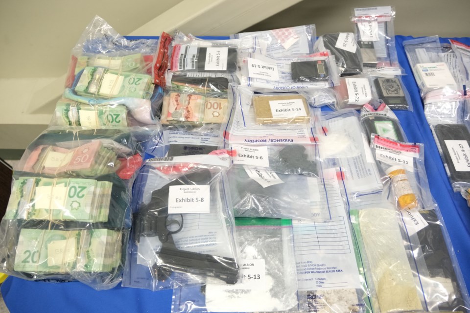Police display some of the drugs and cash recovered in Project Albion. (NAPS handout)