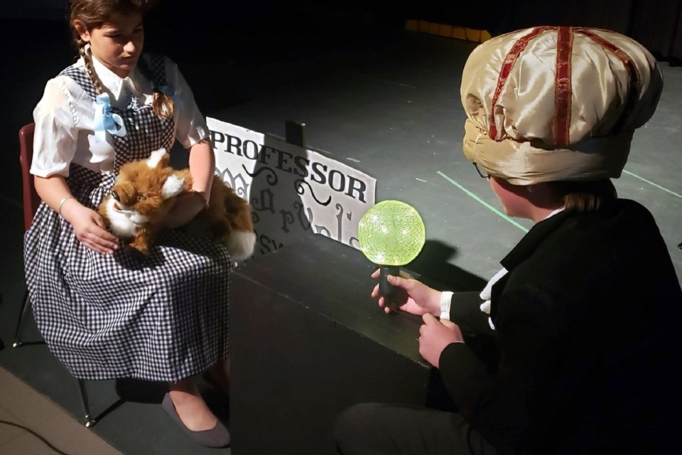 Dorothy meets Professor Marvel during Our Lady of Lourdes Catholic School's presentation of The Wizard of Oz. (Marya Kalen photo)