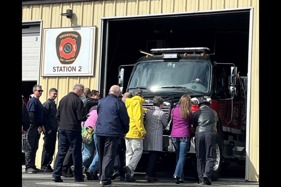 Mayor James McPherson, municipal councillors, members of the fire department and the Marino family conduct the "push in" ceremony on the new fire truck on April 18, 2024.