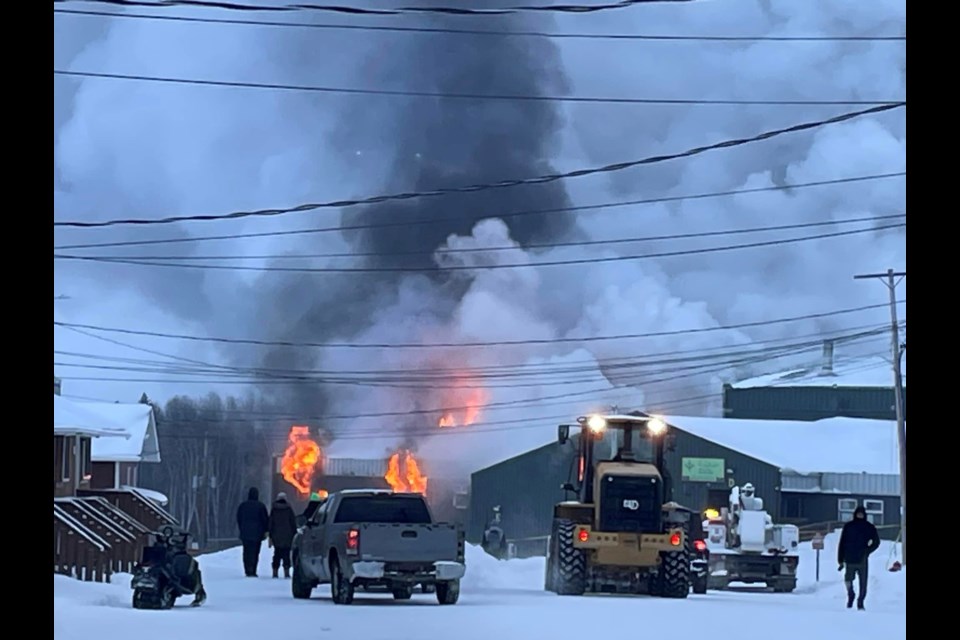 Firefighters from the community work diligently to fight the blaze at the John C. Yesno Education Centre in Eabametoong First Nation on Jan. 25, 2024.