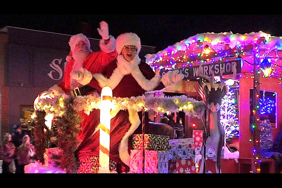 The Festival of Lights Parade and Christmas Tree lighting drew hundreds of people downtown Friday evening. Here are Santa and Mrs. Claus on the Parkers Hardware float.