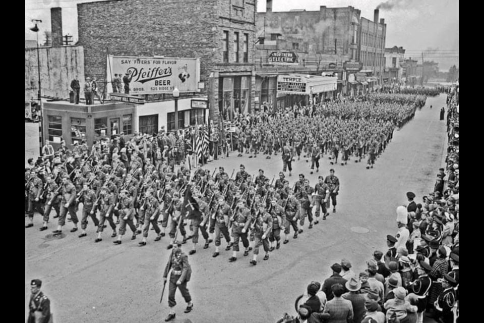 The 131st Infantry marches south on Ashmun Street near Maple Street during "M-Days" May 15, 1942 with approximately 10,000 people watching   