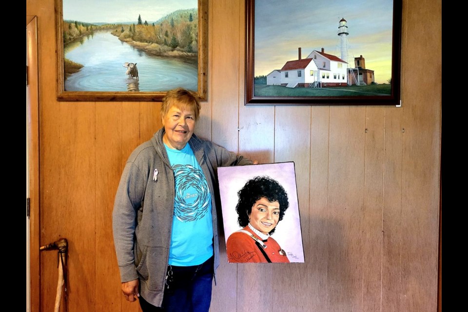 Sault Ste. Marie native Jeanne M. Tubman holding an autographed portrait of the late Nichelle Nichols, who played Lieutenant Nyota Uhura in Star Trek and its film sequels