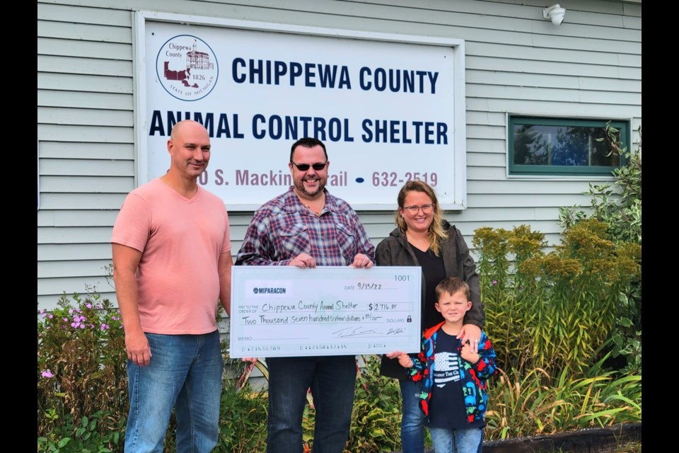 Michigan Paranormal Convention (MIPARACON) Co-directors Tim Ellis and Brad Blair pose with shelter staff member Erin Smith after gifting a check for $2,716.85 to Chippewa County Animal Control Shelter Thursday, Sept. 15, 2022