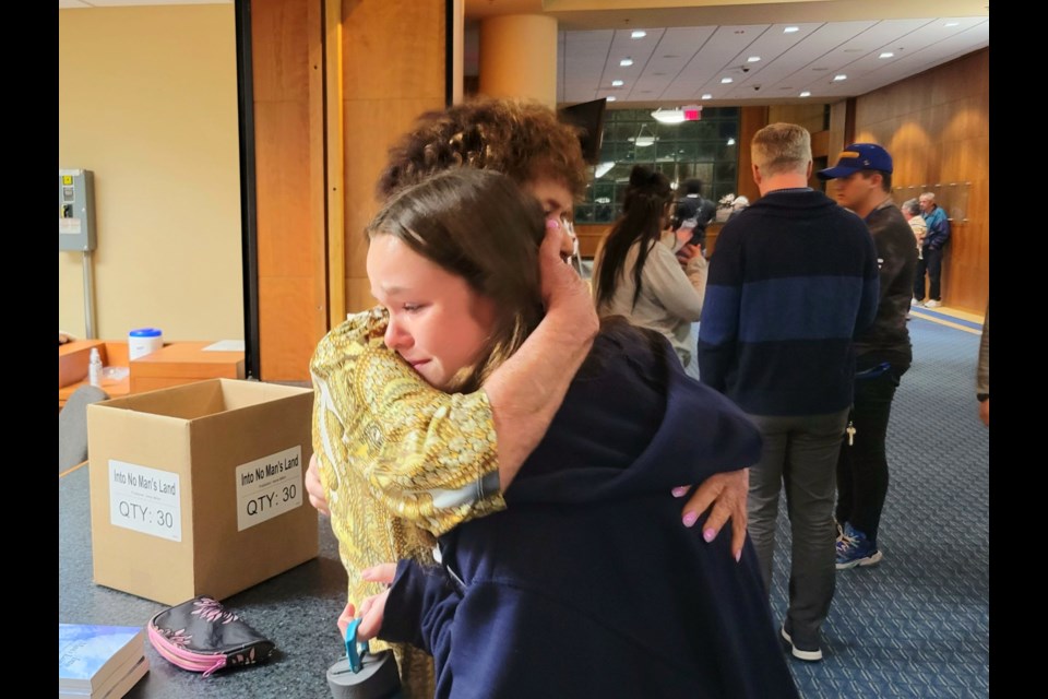 Irene Miller hugs St. Mary's Catholic School eighth grade student Ashtin Kay in Sault Ste. Marie Michigan.
