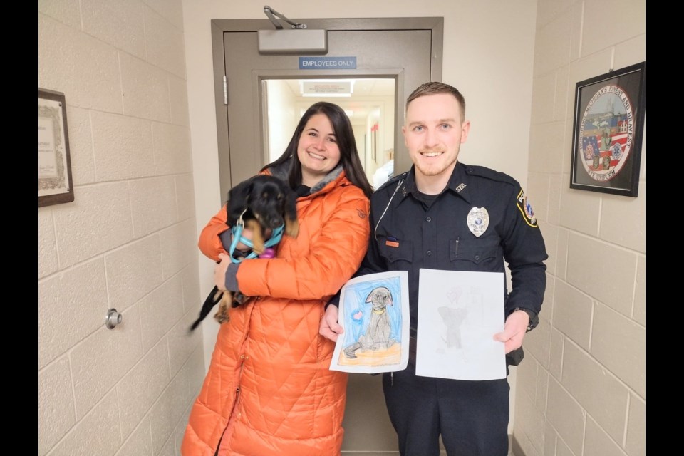 Sault Ste. Marie Mich. City Police Officer Tyler Nousen and fiancée Josi Whipple welcome the puppy he rescued from the Spruce Street Bridge canal to their home on Friday, Nov. 18, 2022