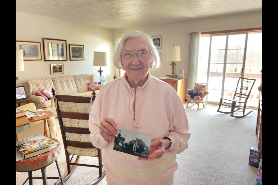 Shirley Welsh Howie, 99, daughter of Chippewa County Sheriff Willard Welsh (1933 to 1942), holds a photo of the jail in the '30s
