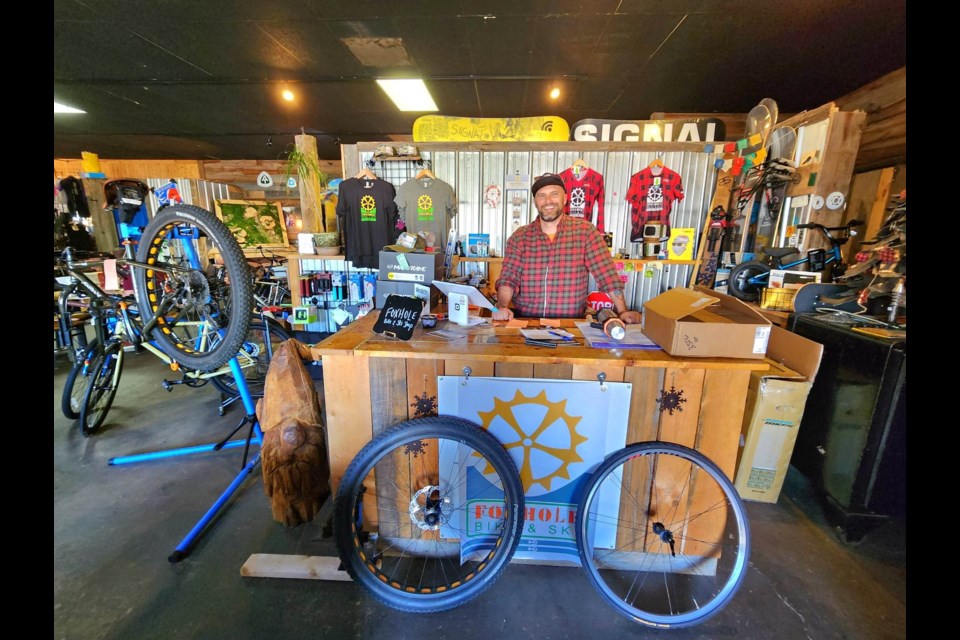 Foxhole Bike and Ski Shop owner Levi Cron working hard at his outdoor recreation repair and sales shop inside of Bird's Eye Outfitters 
