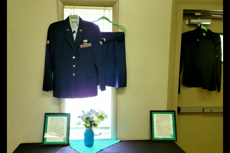 Framed survival stories of sexual assault could be seen on the tables. Hanging above were the clothes worn by victims when attacked.