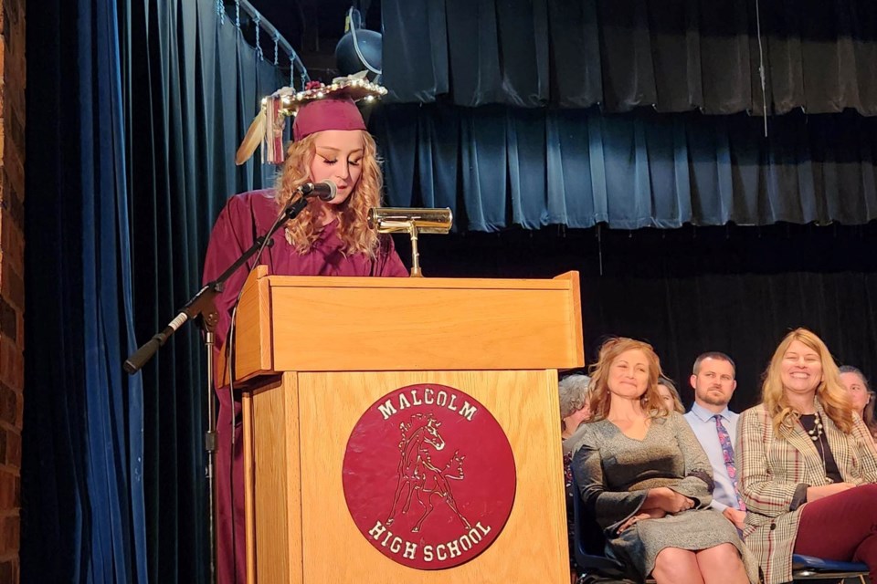 Sault Area Public Schools Malcolm High School Class of 2023 Commencement Speaker Isis Howell speaking with Principal Sandra Sawyer and Superintendent Amy Scott-Kronemeyer seated behind her at graduation Thursday, May 25