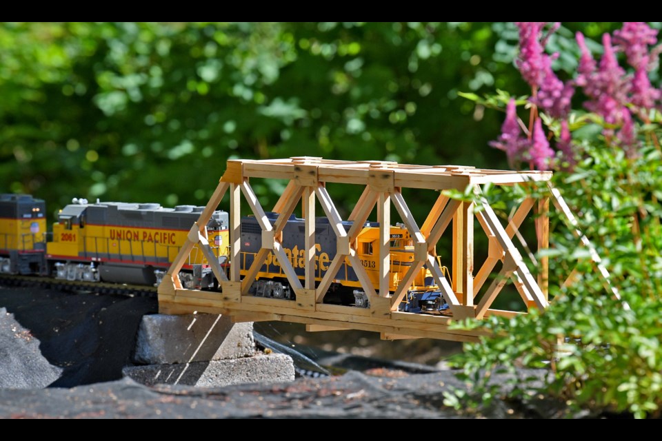 Eric Newmann lends scale to his garden railway.