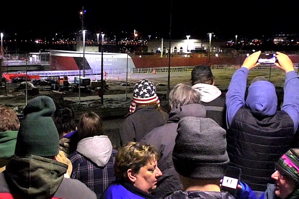 A few hundred people packed the viewing platform at midnight to photograph, video, and talk about the 1004' x 105' Edwin H. Gott slowly working its way into the Poe Lock from the east end of the Soo Locks.