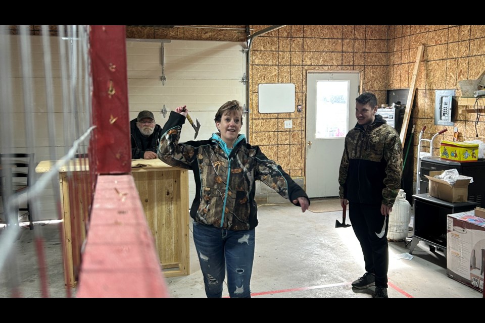 There are four alleys to throw axes inside a heated building. Here Nikki Alexander is about to take a throw.