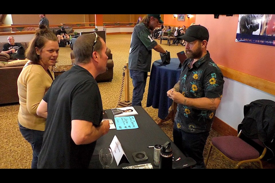 Jack Osbourne, son of rock legend, Ozzy Osbourne, talks to a couple of fans Saturday afternoon.