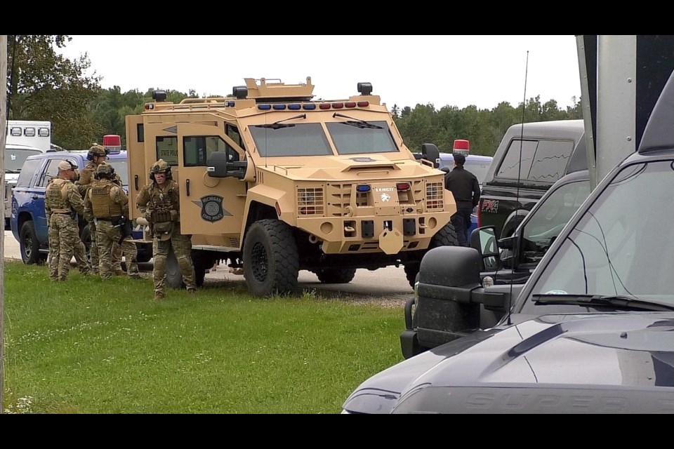 Dozens of officers from different agencies set up staging area at 9 mile road and Riverside Drive in Bruce Township.