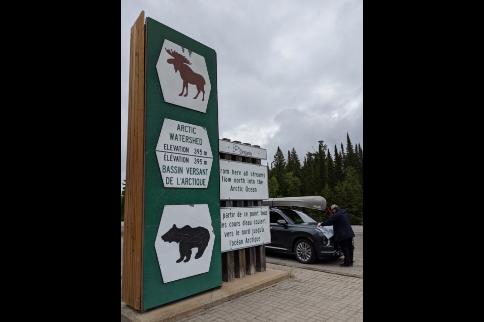  On one side of the sign it states:  "From here all streams flow north into the Arctic Ocean."  