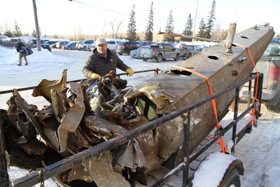 Brian Emblin stands beside the original pontoon from the plane crash wreckage.  It was displayed at a fundraiser at the McIntyre Arena in Timmins this winter, pre COVID-19.  Note the axe hole, police searched for gold as part of the Bill Barilko legend.