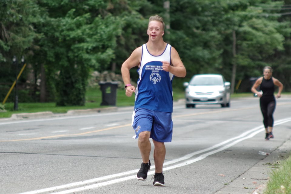 Carter Simpson reaching his 1000 km goal, with his mother Ann Liz close behind. Michael Purvis/SooToday