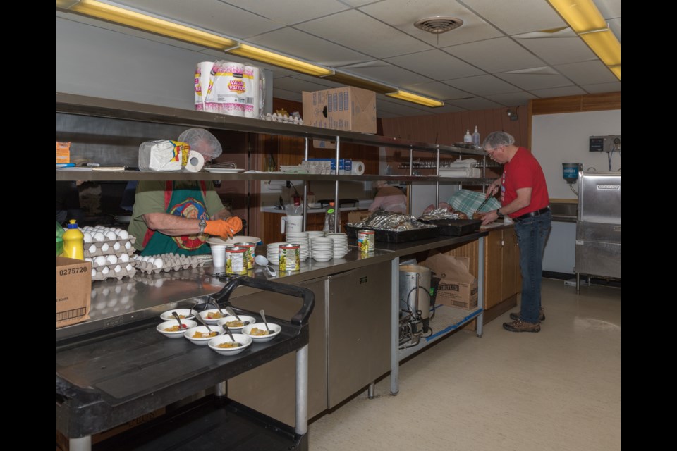 Volunteers Mike McWatters and Bill Bennett in preparation for the meal on Shrove Tuesday at Royal Canadian Legion Branch 25.  Violet Aubertin for SooToday