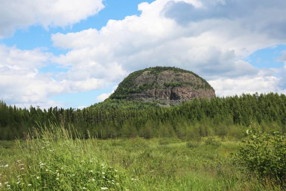 There are a couple of vantage points to see Mount Cheminis from a distance, see the map link, a summer shot.